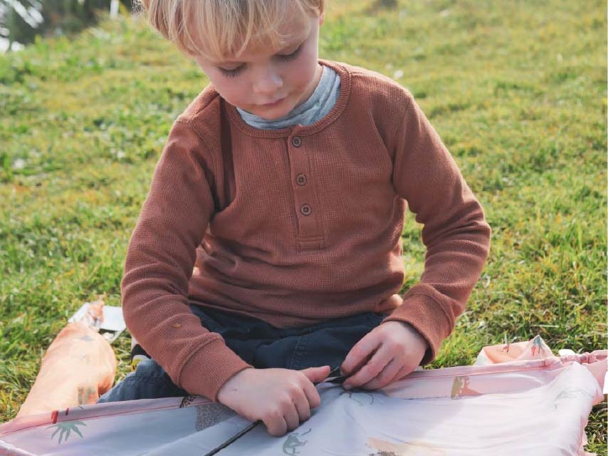 Young boy assembling a kite